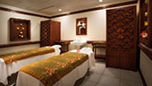 Two massage tables in an Asian-themed spa treatment room