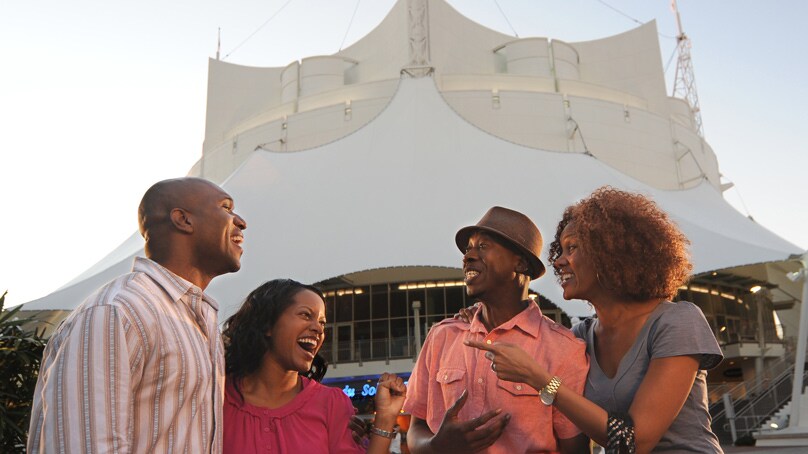 Two couples standing outside of La Nouba Theater at Disney Springs in Florida