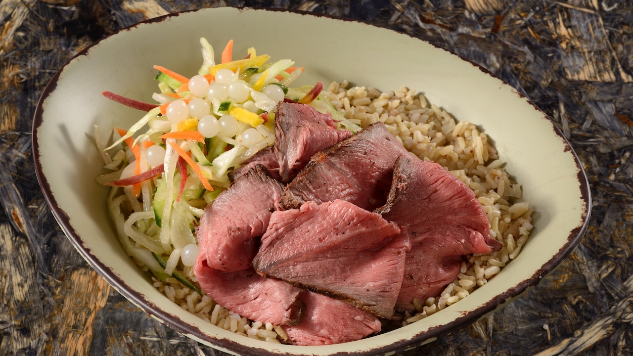 A slow-roasted sliced grilled beef bowl served with vegetable slaw, boba balls and brown rice